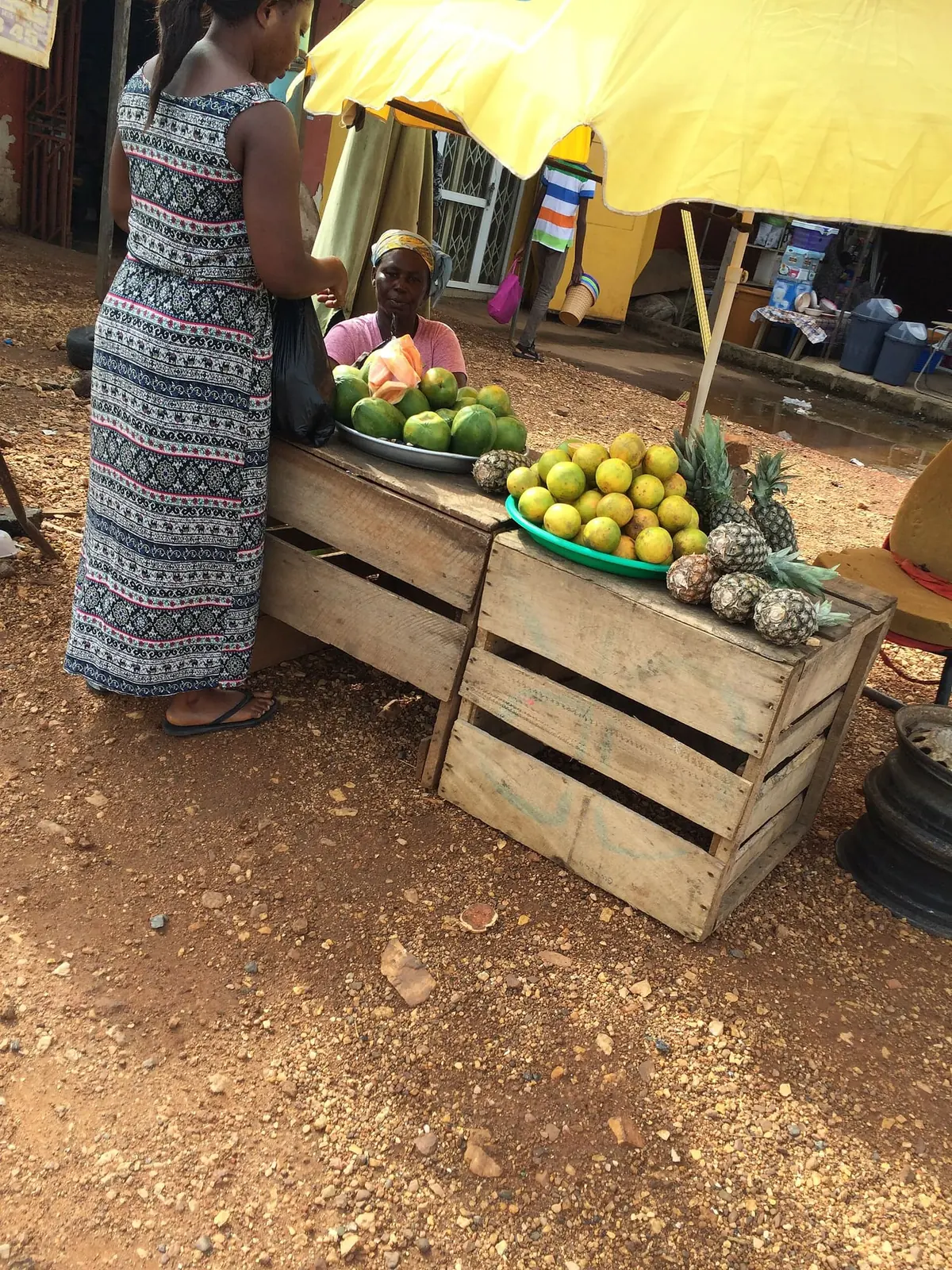 Workers loading crates of citrus at the roadside
