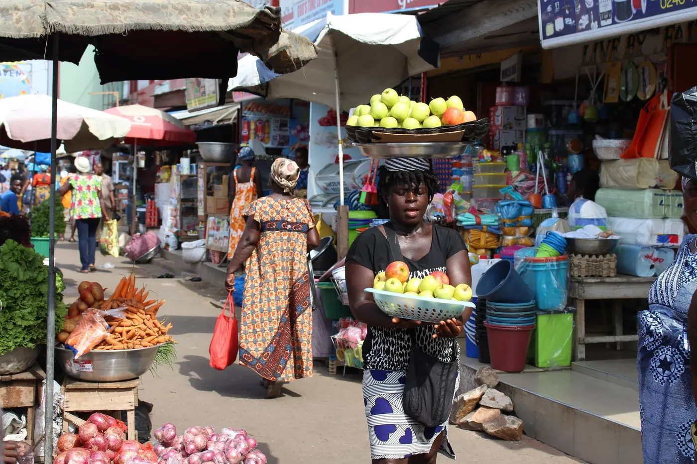 A market trader arranging fresh produce on a stall